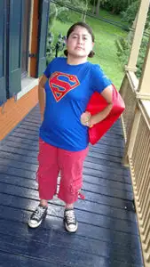 Child wearing a superhero costume.