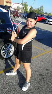 Child holding up a tennis racket.