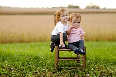The Oglesby twins, Shylah and Selah, pose for photo on their family's farm. 